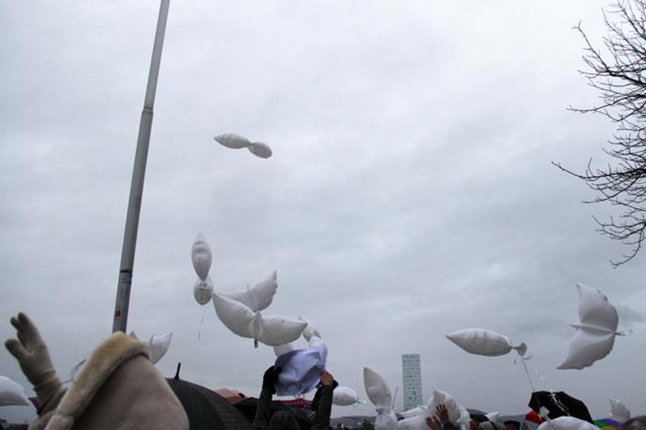 Weisse Ballone in Taubenform stiegen von der Pfalz des Münsters als Friedenssymbole in den grauen Himmel auf. Der Föhnsturm, der über Basel hinwegfegte, wirbelte sie durcheinander und bremste ihren Flug. | Mission 21/Meret Jobin