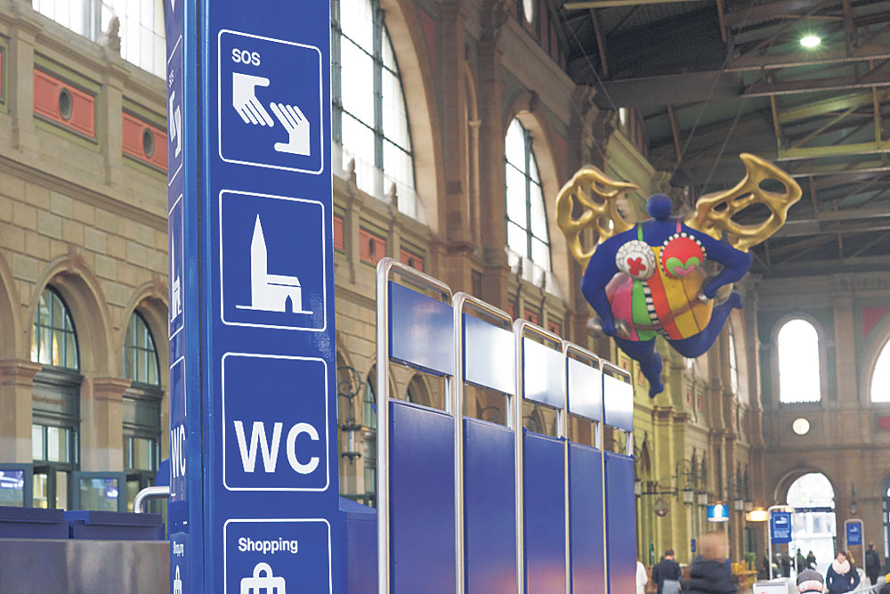 Der Wegweiser zur Bahnhofkirche Zürich, unter dem Engel von Niki de St. Phalle